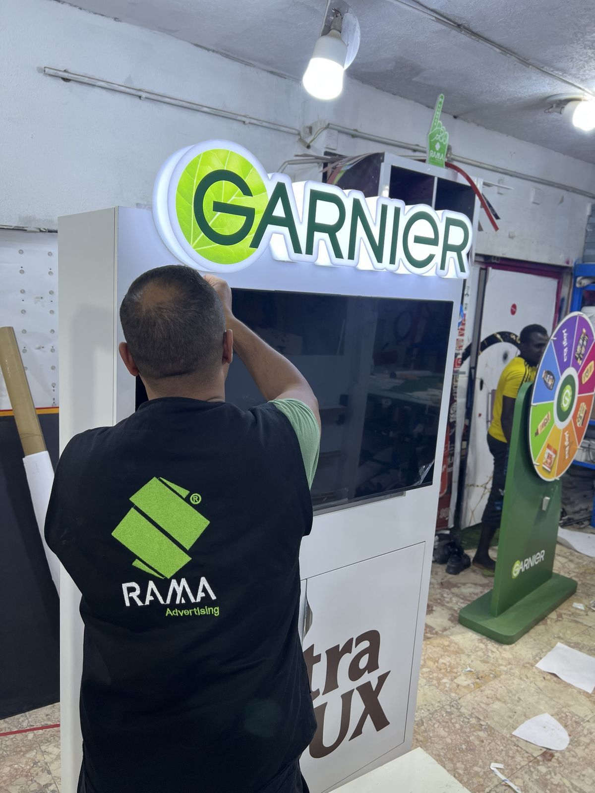 RAMA team installing an illuminated sign